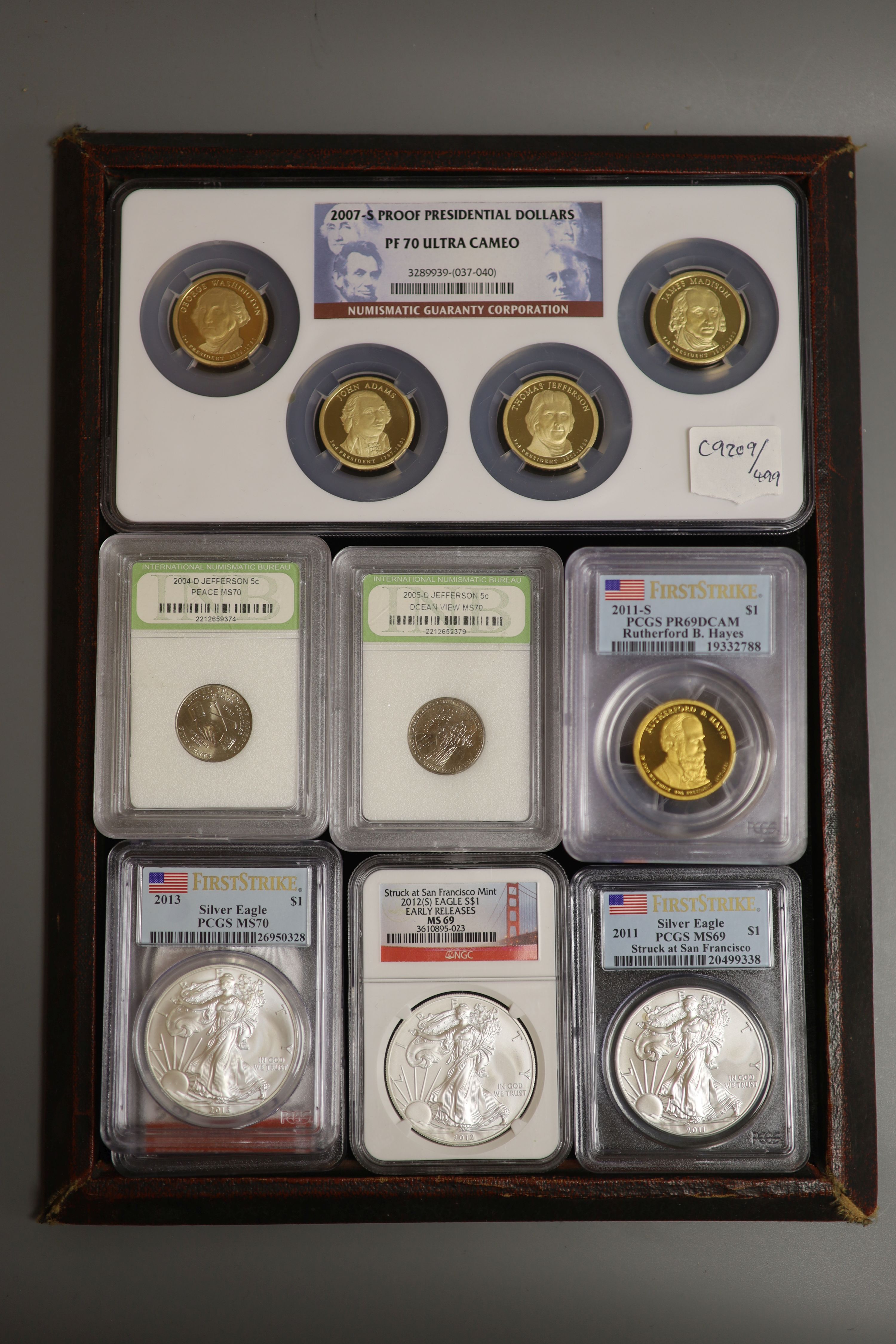 A group of US proof or uncirculated coins in capsules -, Four Silver Eagle $1, 2011 2013 2012 x 2, four 2007S Proof presidential dollars, four 5 cents 2004-6, four 2011s presidential dollars
